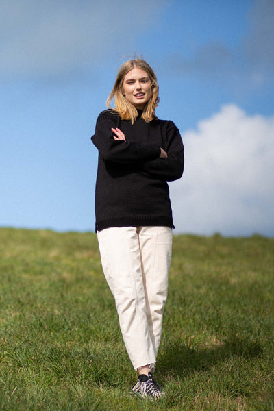 Black Traditional Guernsey Jumper on a wooden hanger