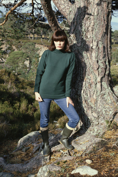 Dark Green Traditional Guernsey Jumper on wooden hanger