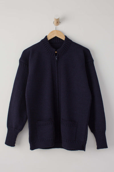 Navy Zipped Guernsey Jacket on a wooden hanger