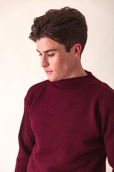 Burgundy Traditional Guernsey Jumper on a wooden hanger