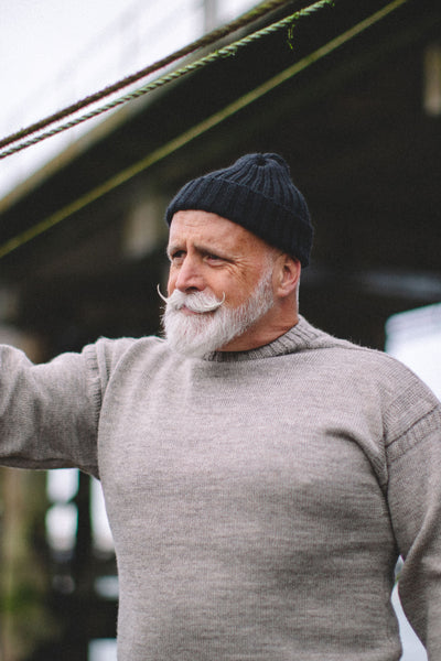 close up of our Navy Dobbo, a short knitted beanie