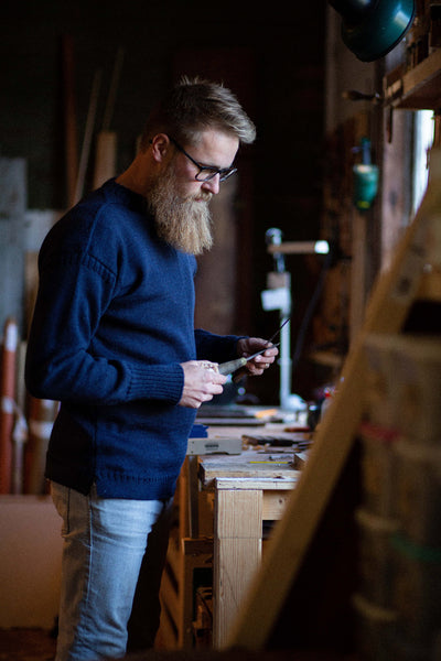 Navy Blue Traditional Guernsey Fishermans Jumper on a wooden hanger
