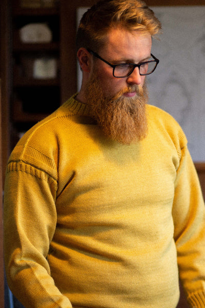 Mustard Traditional Guernsey Jumper on a wooden hanger