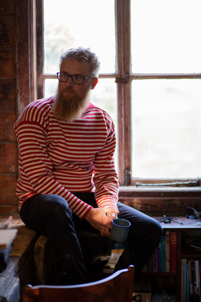 Red & Aran Striped Traditional Guernsey Jumper on a wooden hanger