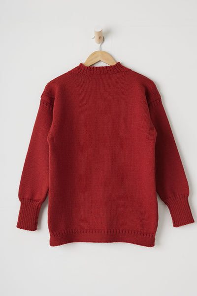 Breton Rouge coloured Traditional Guernsey Fishermans Sweater on a wooden hanger