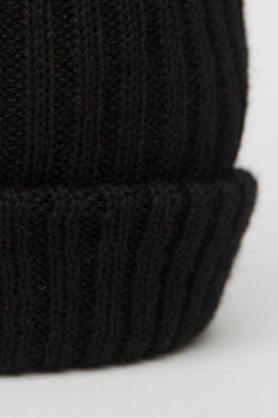 close up on black knitted beanie