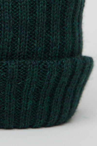 close up of dark green knitted beanie