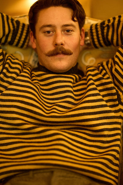 Charcoal & Mustard Striped Traditional Guernsey Jumper on wooden hanger