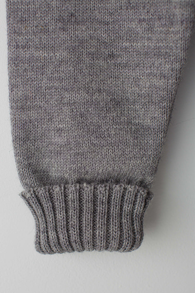 Folded cuff detail on a light Grey Traditional Guernsey