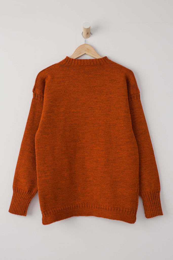 Burnt Orange Traditional Guernsey Jumper on wooden hanger