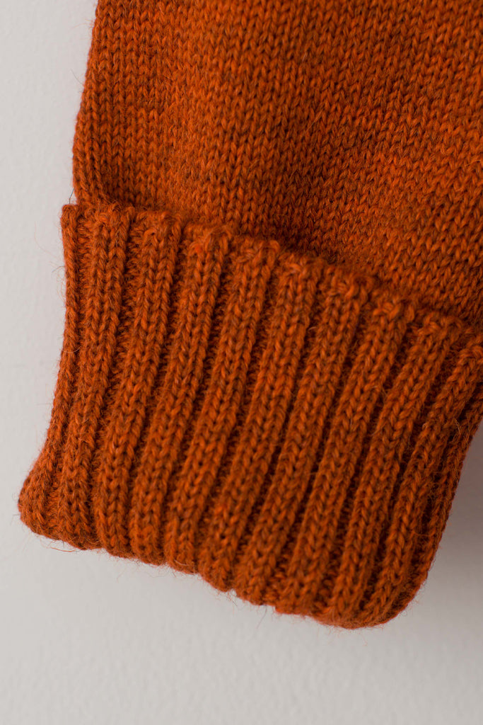 Folded cuff detail on a Burnt Orange Traditional Guernsey
