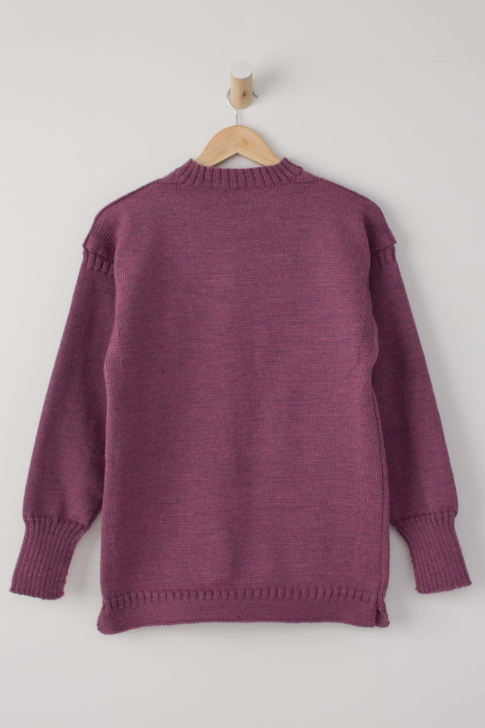 Lupin Pink Traditional Guernsey Jumper on a wooden hanger