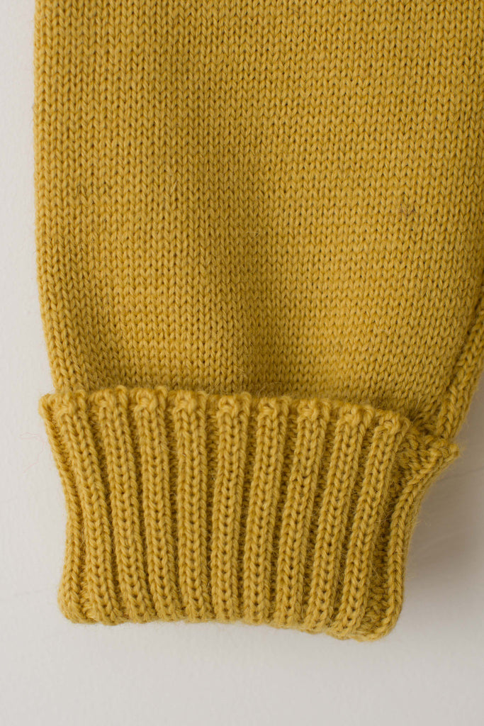 Folded cuff detail on a Mustard Traditional Guernsey