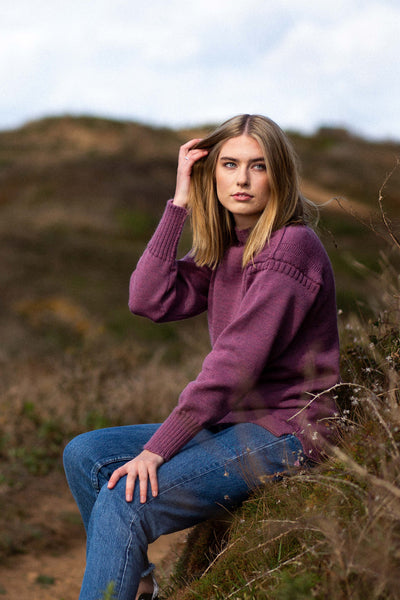 Lupin Pink Traditional Guernsey Jumper on a wooden hanger