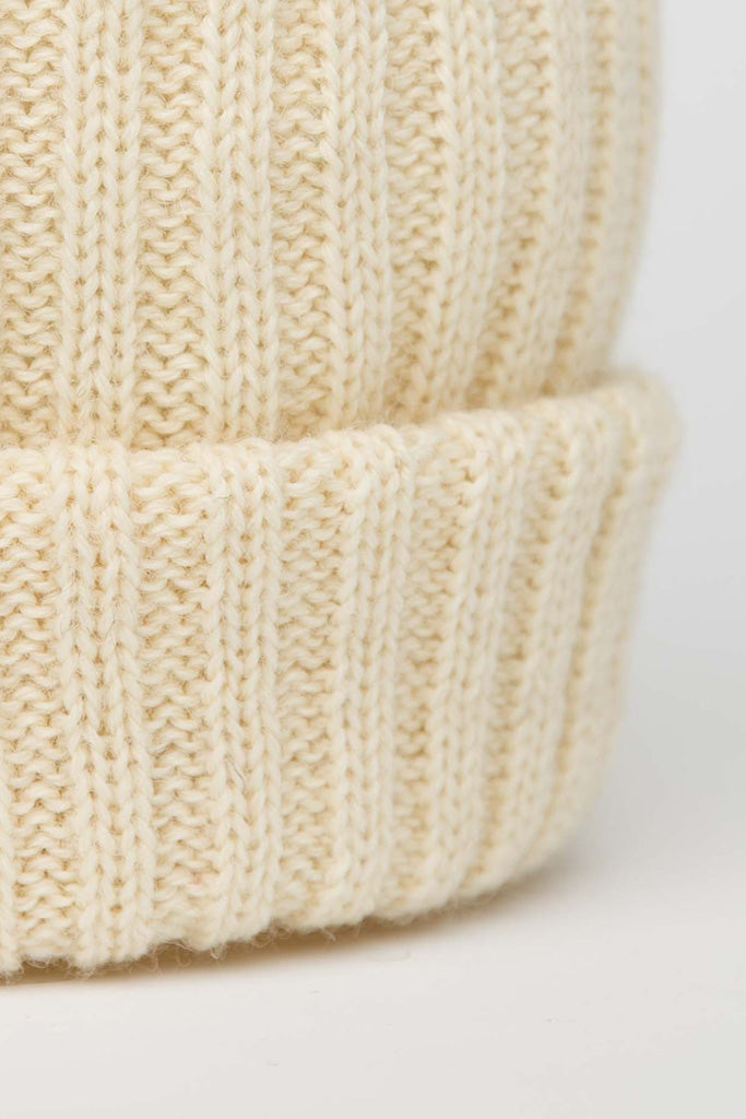 Close up view of knitted beanie in Aran colour